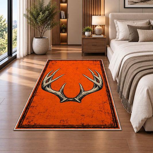 Blaze Orange Antlers rug in a bedroom beside the bed