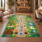Green animal footprint hopscotch rug with colorful numbers, flowers and friendly animals, shown beside seating in a bright room