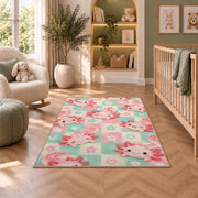 Pastel Checkered Axolotl Rug in a nursery with a crib and armchair