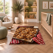 Chocolate chip cookie tray rug in a nursery with a crib and armchair