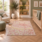 Pink tutu on hanger rug in a nursery with a crib and armchair