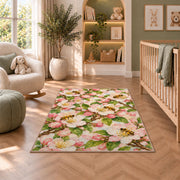 Apple Blossom Bees Rug in a nursery with a crib and armchair