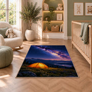 Orange Tent Under the Milky Way rug in a nursery with a crib and armchair