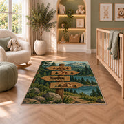 Camping Trail Signpost rug in a nursery with a crib and armchair