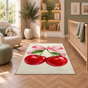 Cherry Bow Rug in a nursery with a crib and armchair