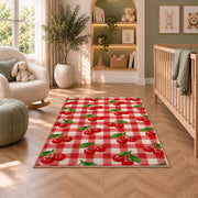 Gingham Cherry Rug in a nursery with a crib and armchair