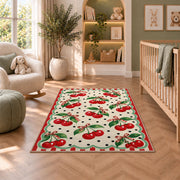 Retro Cherry Polka Dot Rug in a nursery with a crib and armchair
