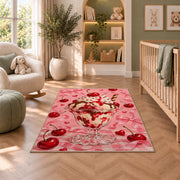 Cherry Sundae Rug in a nursery with a crib and armchair
