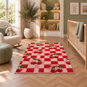 Checkered Cherry Rug in a nursery with a crib and armchair