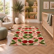 Geometric Cherry Rug in a nursery with a crib and armchair