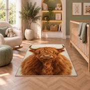 Highland Cow Portrait Rug in a nursery with a crib and armchair
