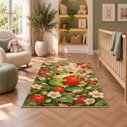 frog hugging a strawberry rug in a nursery with a crib and armchair