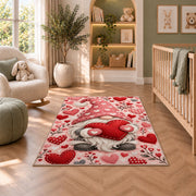 pink gnome hugging a heart rug in a nursery with a crib and armchair