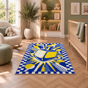 Pop Art Dreidel Rug in a nursery with a crib and armchair