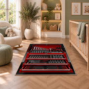 Red toolbox with open drawers rug in a nursery with a crib and armchair