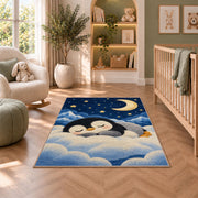 Sleeping Baby Penguin Rug in a nursery with a crib and armchair