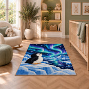 Aurora Penguin Rug in a nursery with a crib and armchair