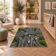 Highway interchange from above rug in a nursery with a crib and armchair