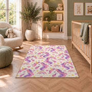 unicorn heads pattern with rainbows rug in a nursery with a crib and armchair