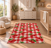 Gingham Cherry Rug in a nursery beside a crib and dresser