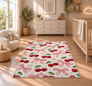 Cherry and Bow Pattern Rug in a nursery beside a crib and dresser