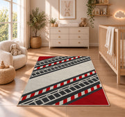 Fire Ladder Stripe rug in a nursery beside a crib and dresser
