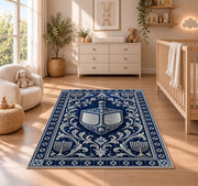 Silver Dreidel Rug in a nursery beside a crib and dresser