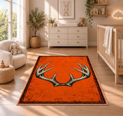 Blaze Orange Antlers rug in a nursery beside a crib and dresser
