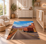 Semi truck on desert highway rug in a nursery beside a crib and dresser