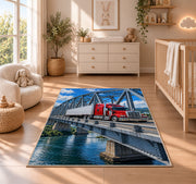 Semi truck crossing a steel bridge rug in a nursery beside a crib and dresser
