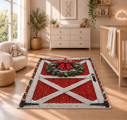 Red Barn Door Christmas Wreath rug in a nursery beside a crib and dresser
