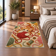 Kitten Playing with Yarn Rug in a bedroom beside the bed
