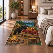 Black Bear Campsite Picnic rug in a bedroom beside the bed