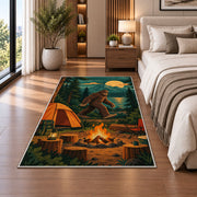 Bigfoot Campsite rug in a bedroom beside the bed