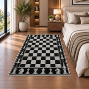 black and white chessboard rug in a bedroom beside the bed
