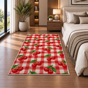 Gingham Cherry Rug in a bedroom beside the bed