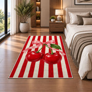 Candy Stripe Cherry Rug in a bedroom beside the bed