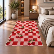 Checkered Cherry Rug in a bedroom beside the bed
