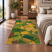 Patchwork Farm Fields Aerial rug in a bedroom beside the bed