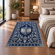 Silver Dreidel Rug in a bedroom beside the bed