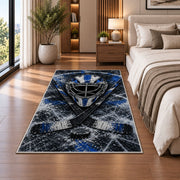 Goalie Mask Crossed Sticks rug in a bedroom beside the bed
