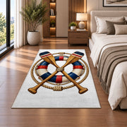 Crossed oars and life ring rug in a bedroom beside the bed