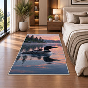 Loon and chick at sunrise rug in a bedroom beside the bed