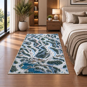 Ski resort trail map rug in a bedroom beside the bed