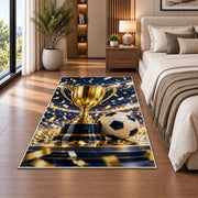gold trophy and soccer ball rug in a bedroom beside the bed