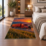 Red semi truck at sunset rug in a bedroom beside the bed