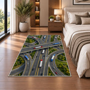 Highway interchange from above rug in a bedroom beside the bed