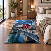 Semi truck crossing a steel bridge rug in a bedroom beside the bed