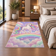 white unicorn on a rainbow rug in a bedroom beside the bed