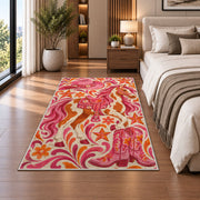 Pink cowgirl rug in a bedroom beside the bed